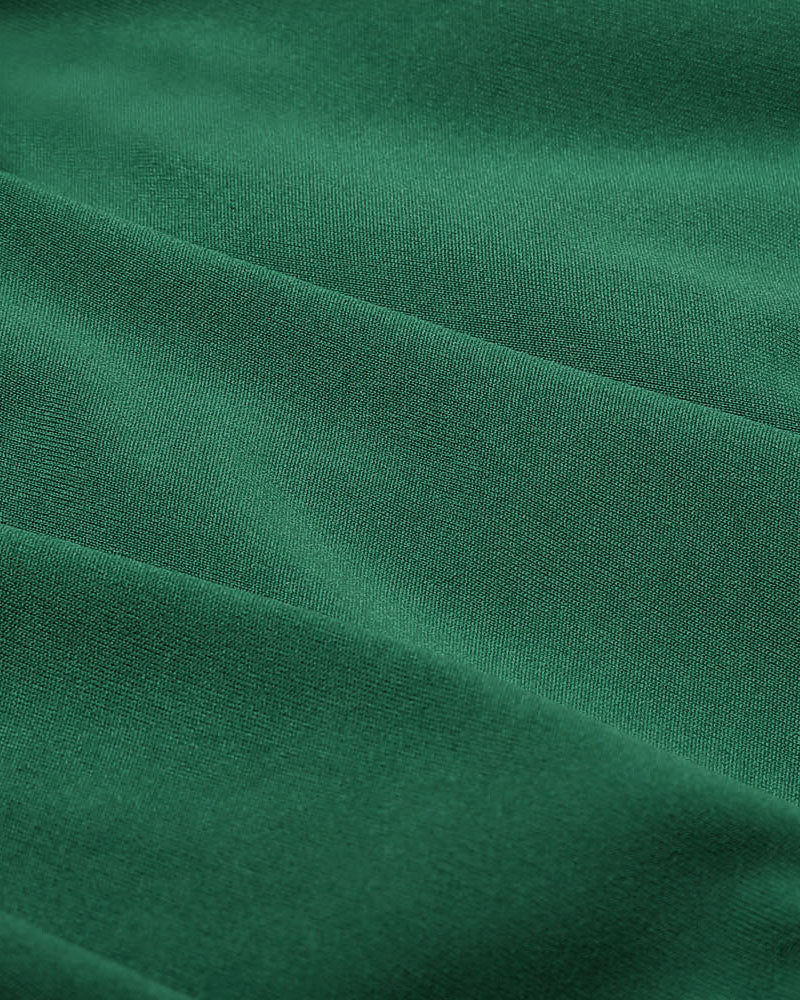 Pleated ruffle mini skirt fabric in dark green with fine textured weave