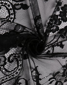 Black floral lace overlay fabric with sheer mesh texture