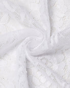 White lace fabric detail with floral embroidery and sheer mesh backing