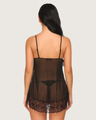 Black lace mesh mini chemise nightie, back view with lace-trim hem and sheer panel