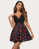 Black mini slip dress with red lip and lipstick pattern, lace bust and straps