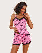 Pink love-print cami pajama set with black lace-trim neckline and matching shorts