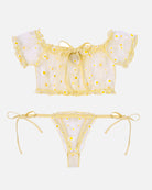 Lace ruffle bra and panty set flat lay with yellow daisy print, off-shoulder bra and thong