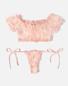 Light pink lace ruffle bra and thong set with bow-tie side straps and floral embroidery