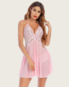 Pink lace halter V-neck nightdress with bow-front detail and flared sheer skirt.