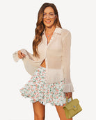 Pleated skater skirt with light background and pink floral print, gathered elastic