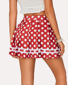 Red pleated school uniform skirt with large white polka dots and layered striped hem