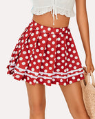Red pleated school uniform skirt with white polka dots and striped hem