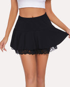 Black pleated mini skirt with ruffled hem and white lace trim, side view