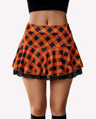 Plaid pleated mini skirt with ruffle hem, orange and blue diamond pattern, lace trim
