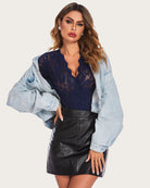 Navy lace long-sleeve bodysuit with deep V neckline and fitted snap-crotch