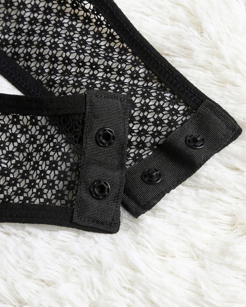 Black mesh snap-crotch bodysuit with buttoned snap placket close-up