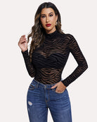 Black sheer mesh turtleneck bodysuit with long sleeves, zebra print, hand on hip