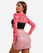 Red and white swirl print mock neck long sleeve crop top, back view.