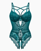 Floral lace harness bodysuit in teal-green lace with crisscross straps and thong cutout