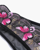 Embroidered mesh panties detail with pink flower motif and decorative stitching