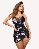 Black lace slip dress with floral print, crisscross front neckline, and side cutouts