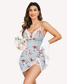 Light blue lace slip dress with floral print, crisscross back straps, and lace-trim hem