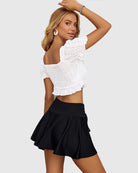 Black high-waist pleated skirt with drawstring waist and flared A-line silhouette
