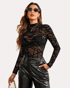 Black long sleeve mock neck mesh crop top with geometric grid pattern and fitted sleeves.