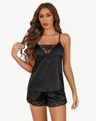 Black satin pajama set with lace-trim camisole and matching shorts with lace hem