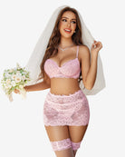 Pink lace lingerie set with underwire bra, mini skirt, and matching garter belt stockings