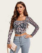 Leopard print sheer mesh crop top with long sleeves and fitted corset-style seams