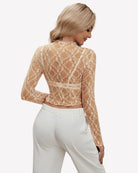 Beige sheer lace long-sleeve mesh top from the back with openwork pattern