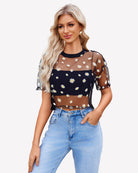 Black sheer mesh crop top with daisy print, round neckline, short sleeves