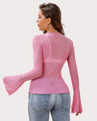 Pink rhinestone mesh top from back view, long flared sleeves and scalloped hem