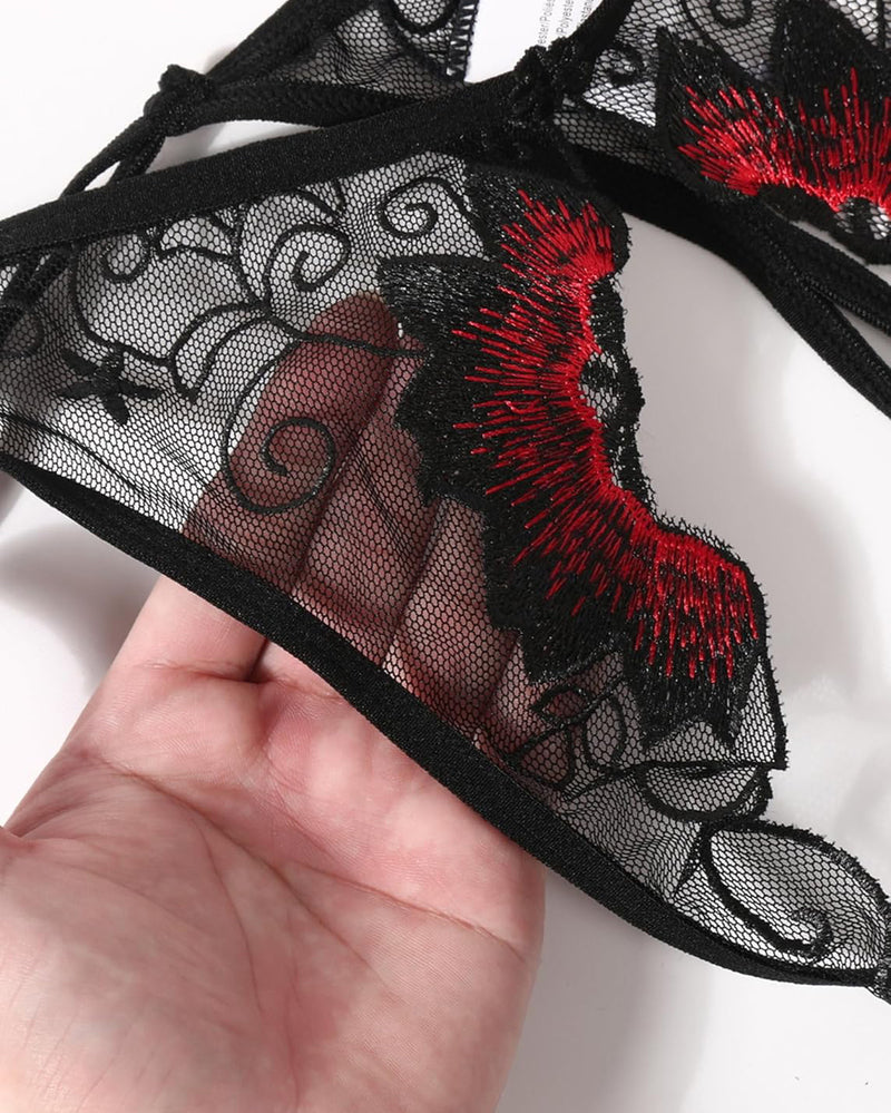 Black mesh thong panty with floral embroidery and scalloped lace trim in red.