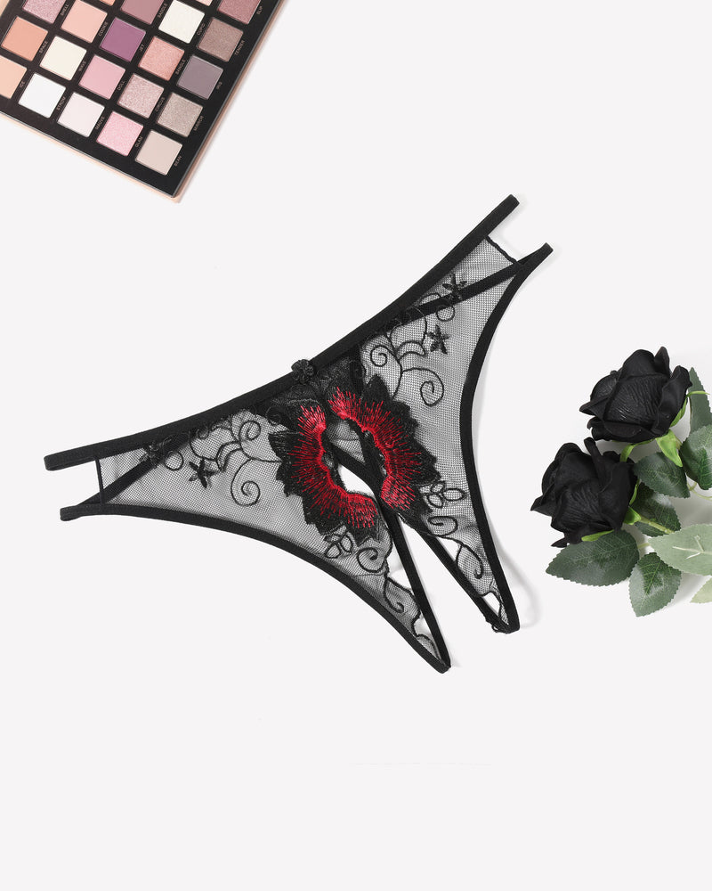 Black mesh thong panty with red floral embroidery, scalloped lace trim, and thin ties.