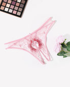 Light pink embroidered thong panties with red eyelet floral swirl and center bow detail