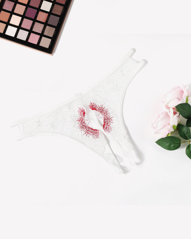 White thong panties with red embroidered floral swirl and lace trim at sides