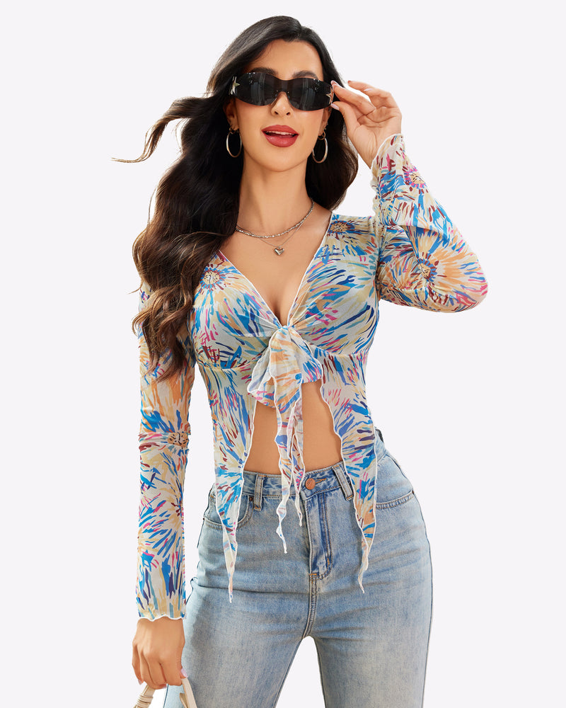 Mesh crop top with long sleeves, tie-front detail, and colorful tropical floral print