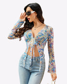 Mesh crop top with long sleeves, tie-front detail, and tropical floral print