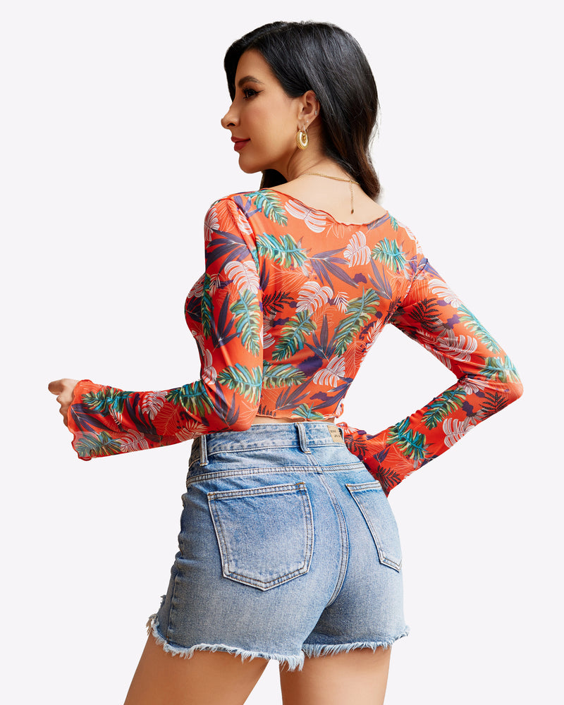 Mesh crop top with long sleeves, tie-front detail, and orange tropical floral print