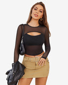 Sheer mesh long sleeve crop top in black with keyhole cutout at bust, side view