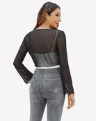 Black sheer mesh tie-front shrug top from back view, long sleeves