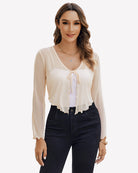Ivory sheer mesh tie-front shrug top with V-neck ribbon and long sleeves
