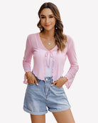 Pink sheer mesh tie-front shrug top with V-neck ribbon drawstring and long sleeves