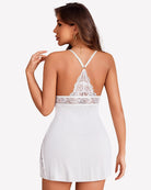 White lace chemise nightgown with crisscross back straps and lace-trimmed waist panel