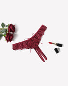 Wine red lace thong briefs with lace panel, bow ties, and crisscross back straps