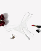 White lace g-string thong with thin strappy sides and floral mesh center