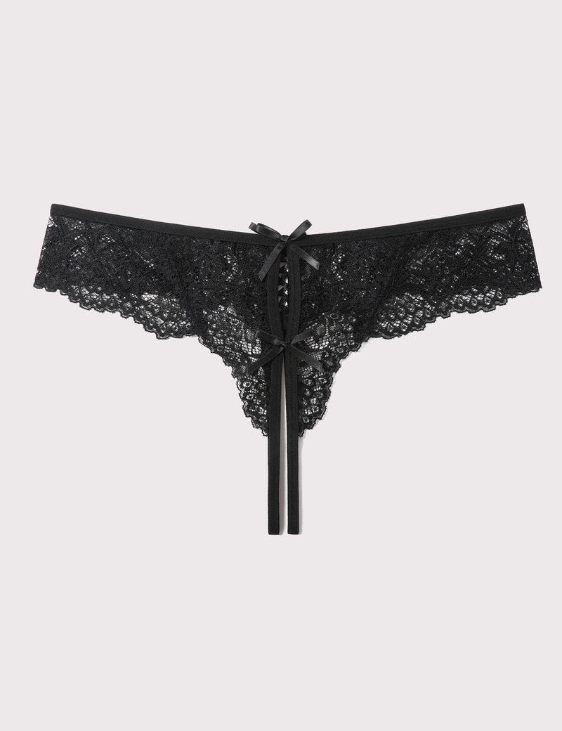 Black lace thong panties with bow and long ribbon ties, flat lay