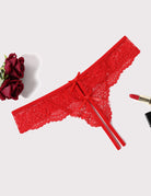 Red lace thong panties with bow ties and scalloped lace trim