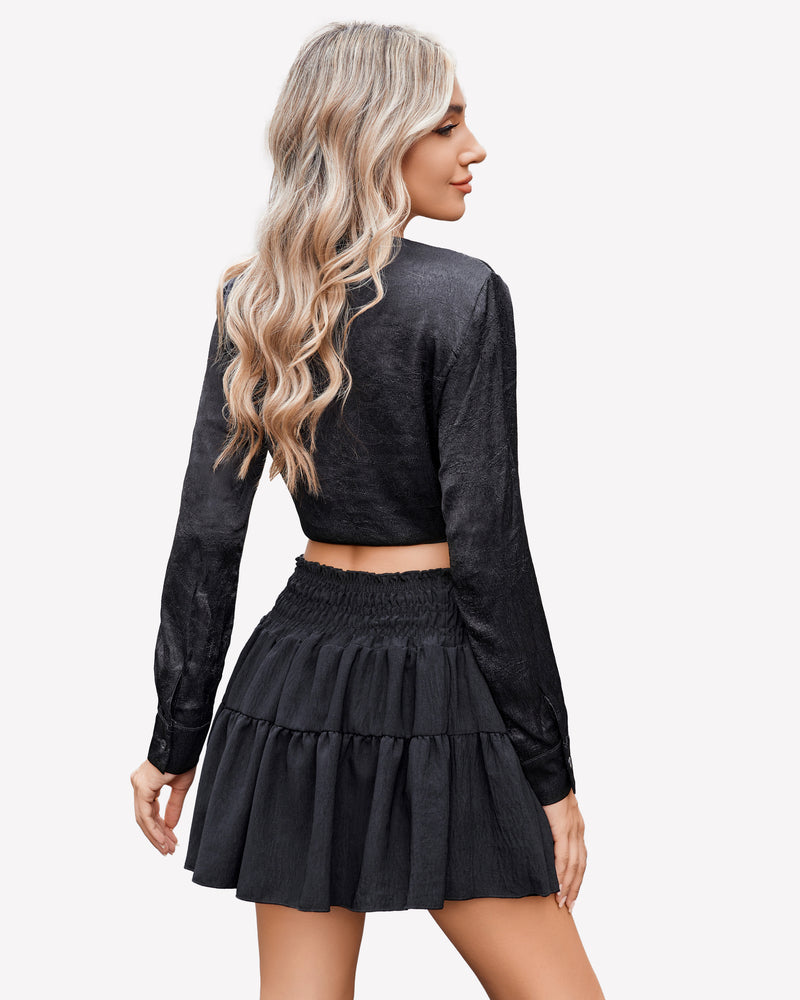 Black smocked waist short A-line skirt with pleated tiered ruffles, shown from side