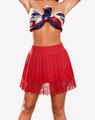 Red high-waist pleated mini skirt with lace trim at the hem and sheer lace layer