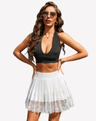 White high-waist pleated mini skirt with scalloped lace hem and sheer lace bottom
