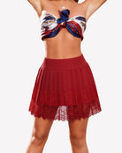 Red high-waist pleated mini skirt with lace-trim hem and fitted waistband